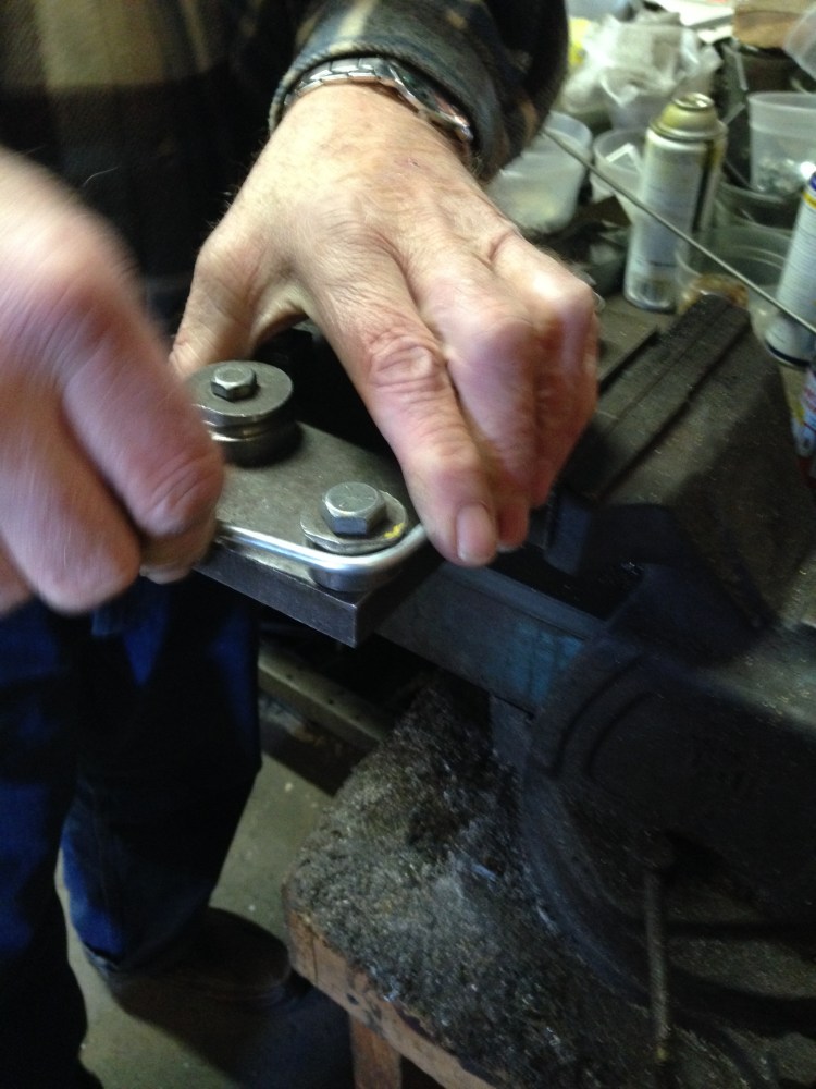 A fixture holds the pipe and applies a bend at just the right spot.