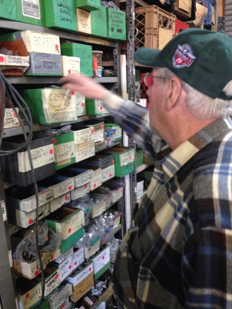 John inspects part of his vast array of parts.