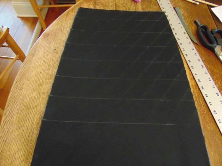 Here the fabric has been glued to the foam and the reference lines for the stitching later. Don't add the lines until after you have glued the cloth, as it will move a little on you up to that point. The lines are done in chalk, which can be wiped away later .