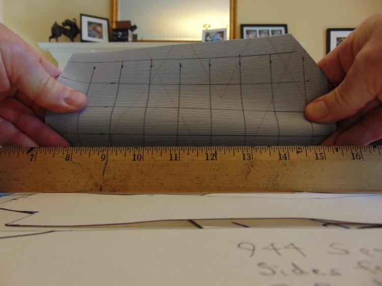 Fabric backed vinyl does not like to stretch in the primary direction of the fabric backing.