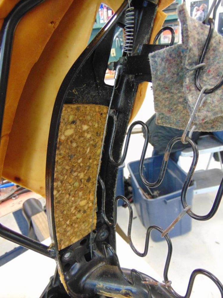 This little guy turned out to be quite the challenge. It is the wire from the seat release lever. Getting it release from the outside is not easy. But if you remove the vinyl and pull back the foam, you can get to it much easier for detachment. 